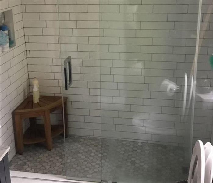 Picture is a bathroom, seemingly normal with no signs of damage.